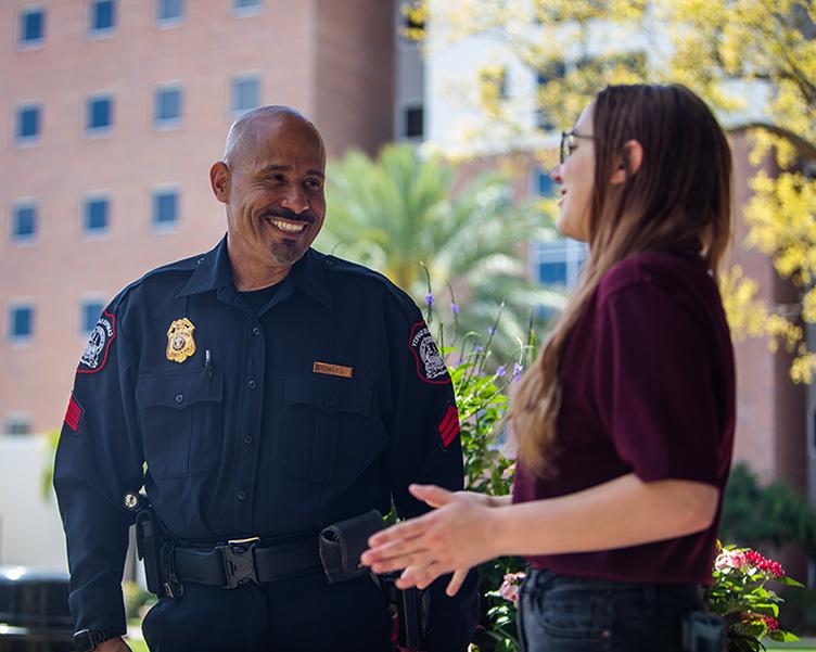 Campus Safety officer speaking with student